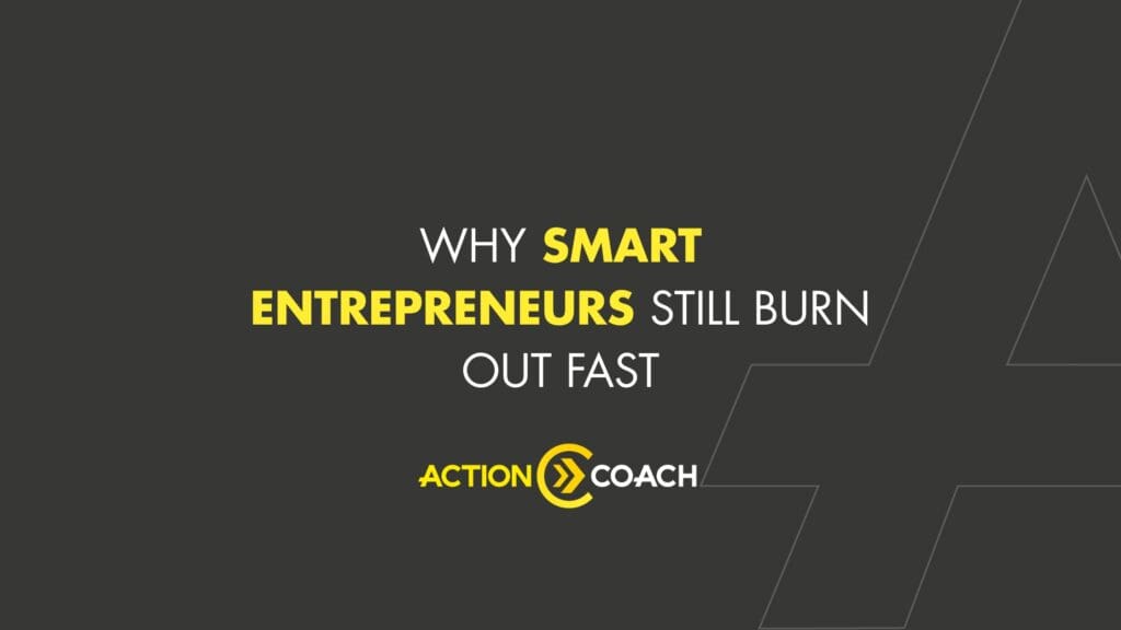 Dark gray graphic with the text: Why smart entrepreneurs still burn out fast in white and yellow, and the ActionCOACH logo at the bottom. Thin white lines form abstract shapes in the corners, highlighting the importance of ROI in Business Coaching.