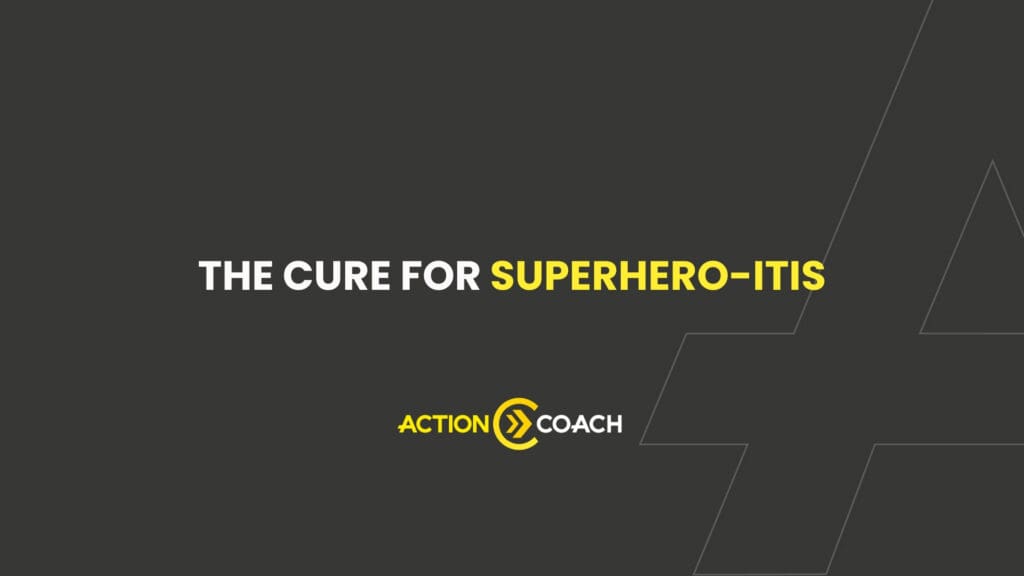 Dark gray background with white text reading “The Cure for Superhero-Itis.” Below, the yellow and white ActionCOACH logo appears. Angular line art decorates the right side, highlighting the power of a business coaching program.